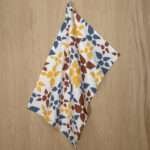 celebration design hanging tea towel in clay from hem and tassel