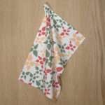 celebration design hanging tea towel in pink from hem and tassel