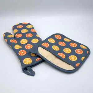faded orange design mitt and pocketed hot pad from hem and tassel