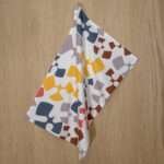 flock and flutter design hanging tea towel in slate from hem and tassel