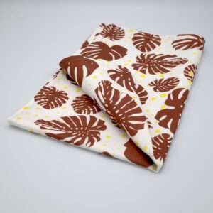 monster ah design clay and yellow tea towel folded from hem and tassel