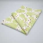 monster ah design mint and clay tea towel folded om hem and tassel