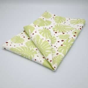 monster ah design mint and clay tea towel folded om hem and tassel