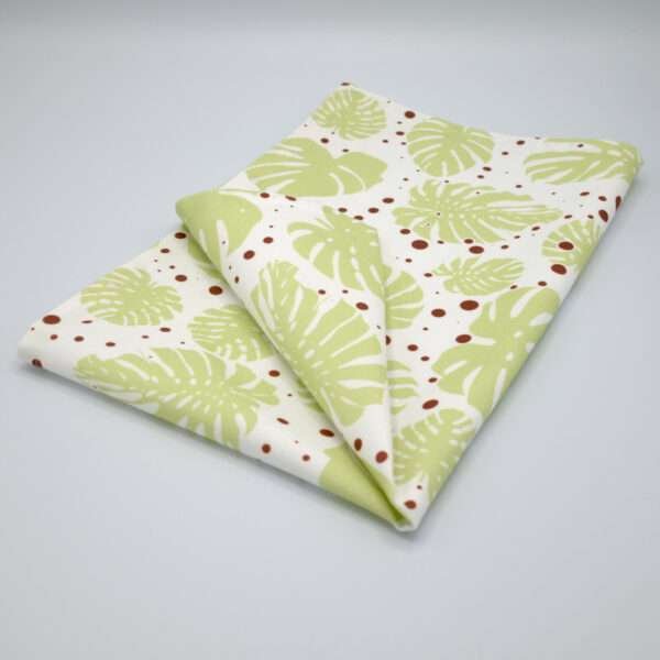monster ah design mint and clay tea towel folded om hem and tassel
