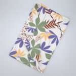 pollen up design tea towel in buff flat folded from hem and tassel