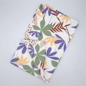 pollen up design tea towel in buff flat folded from hem and tassel