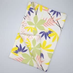 pollen up design tea towel in yellow flat folded from hem and tassel