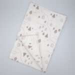 tiny countryside design tea towel in grey flat folded from hem and tassel