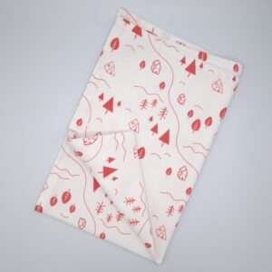 tiny countryside design tea towel in pink flat folded from hem and tassel