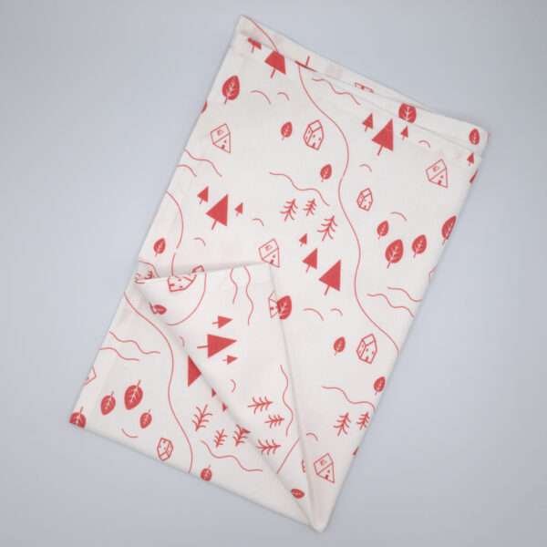 tiny countryside design tea towel in pink flat folded from hem and tassel