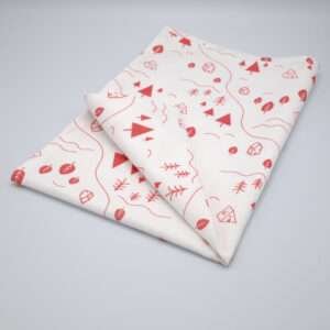 tiny countryside design tea towel in pink folded from hem and tassel