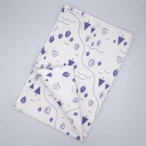 tiny countryside design tea towel in purple flat folded from hem and tassel