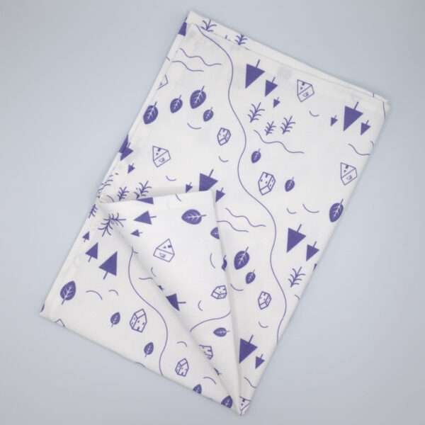 tiny countryside design tea towel in purple flat folded from hem and tassel