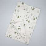tiny countryside design tea towel in turf flat folded from hem and tassel