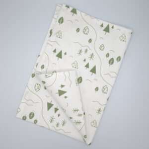 tiny countryside design tea towel in turf flat folded from hem and tassel
