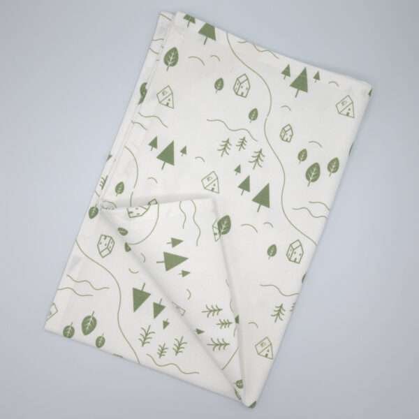 tiny countryside design tea towel in turf flat folded from hem and tassel
