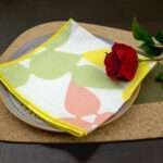 Celebration design Blush Napkin LS on Green Kidney Bean Cork placemat from hem and tassel
