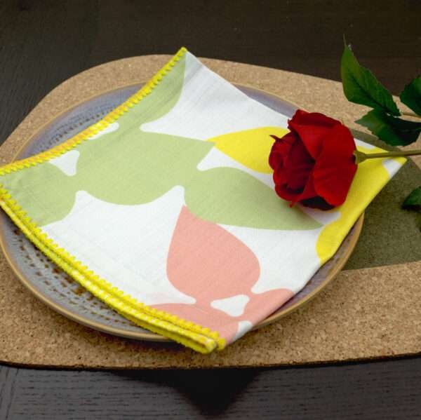 Celebration design Blush Napkin LS on Green Kidney Bean Cork placemat from hem and tassel