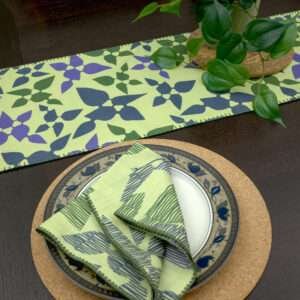 Celebration design Dinner Napkin in green with mint runner LS looking down from hem and tassel