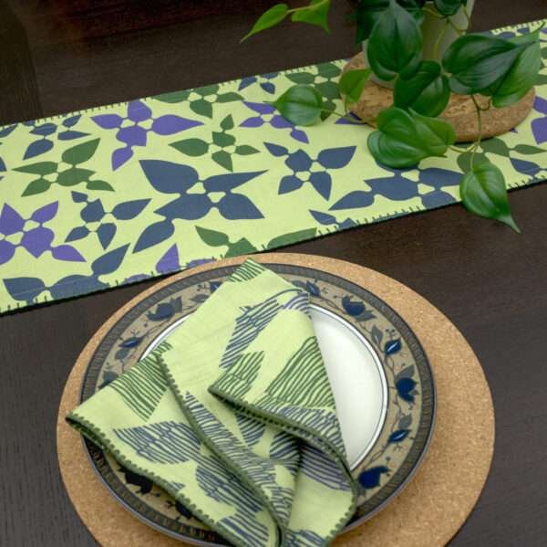 Celebration design Dinner Napkin in green with mint runner LS looking down from hem and tassel
