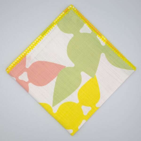 Celebration design dinner napkin in blush flat folded from hem and tassel