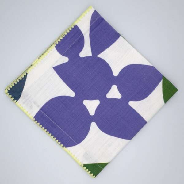 Celebration design dinner napkin in purple flat folded from hem and tassel