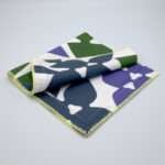 Celebration design dinner napkin in purplefolded from hem and tassel