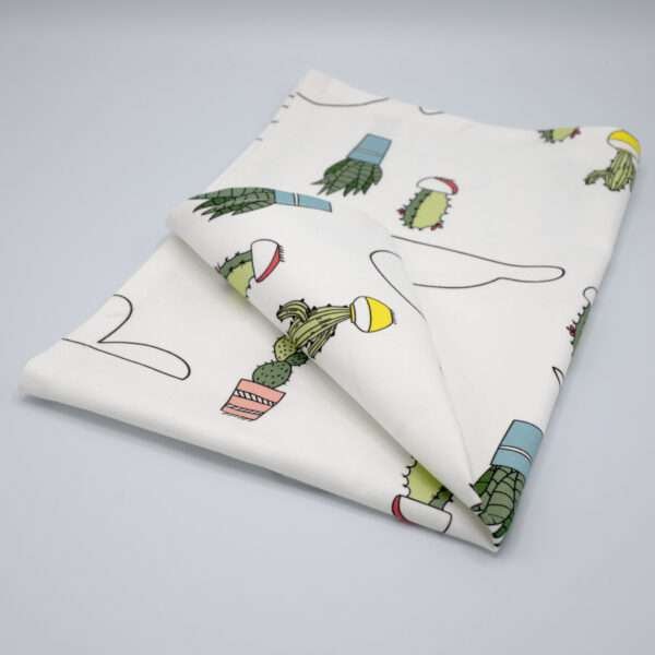 Clouds and cactus design tea towel folded from hem and tassel