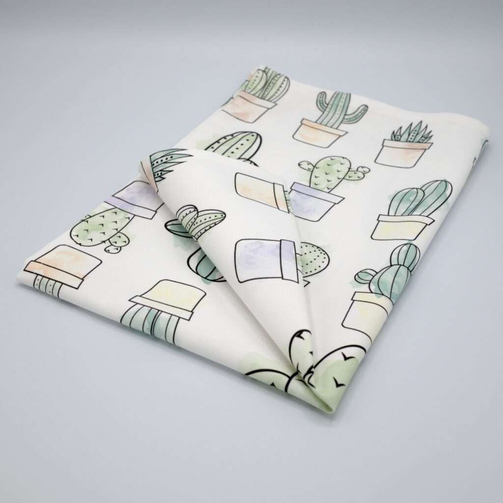 Desert Haze design tea towel folded from hem and tassel