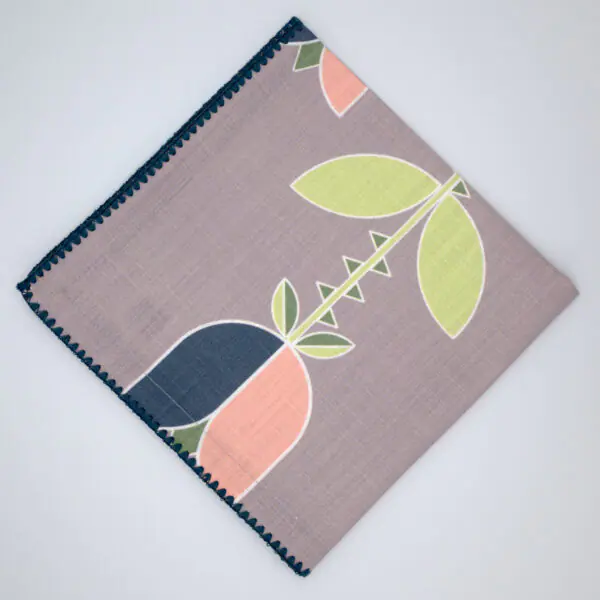 Lip TuLip design dinner napkins in oil flat folded from hem and tassel