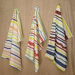 Not straight broad design set of three hanging tea towels from hem and tassel