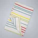 Not straight design medium-slim tea towel flat folded from hem and tassel