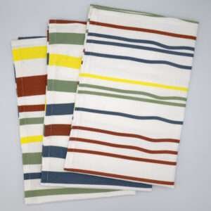 Not straight design set of three bold tea towels fanned out from hem and tassel
