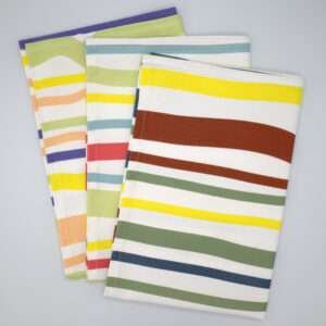 Not straight design set of three broad tea towels fanned out from hem and tassel