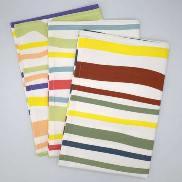 Not straight design set of three broad tea towels fanned out from hem and tassel