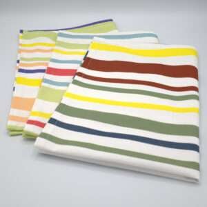 Not straight design set of three broad tea towels folded out from hem and tassel