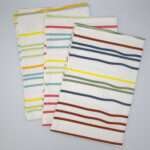Not straight design set of three slim tea towels flat folded from hem and tassel