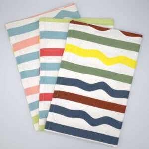 Not straight design set of three standard tea towels fanned out from hem and tassel