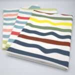 Not straight design set of three standard tea towels folded from hem and tassel