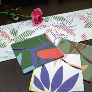 Pollen up design Dinner Napkins in tnree colors with blue table runner LS from hem and tassel
