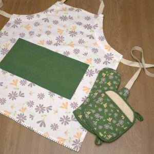 Shy dragonfly design apron with buff and grey flowers flat from hem and tassel