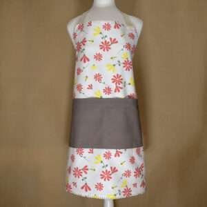 Shy dragonfly design apron with pink flowers on mannequin from hem and tassel