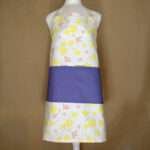Shy dragonflies design apron with yellow flowers on mannequin from hem and tassel