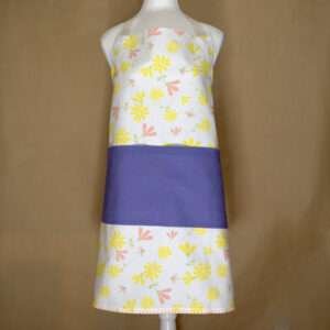Shy dragonflies design apron with yellow flowers on mannequin from hem and tassel