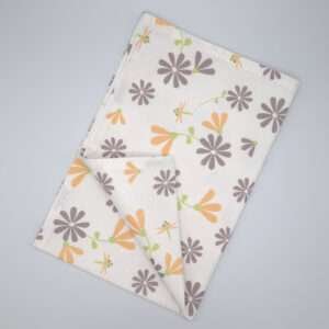 Shy dragonfly flowers design tea towel in grey and buff flat folded from hem and tassel