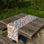 Table runner of celebration design in midnight on pHem And Tassel