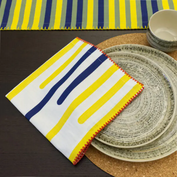 Yellow Piano design dinner Napkin in top view also showing yellow piano table runner and graphic peel cork placemat