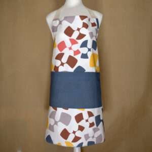 flock and flutter design apron in grey on mannequin from hem and tassel