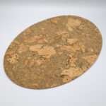 graphic oval design cork placemat seen as single from hem and tassel
