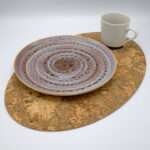 graphic oval design cork placemat with plate and mug from hem and tassel
